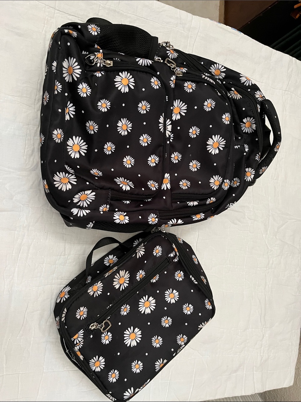 Black Daisy Print Backpack and insulated lunch bag.